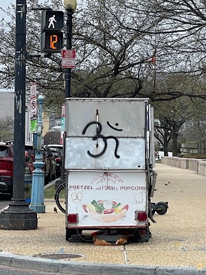 I’m sign painted on side of food cart selling pretzels, half smokes, popcorn.