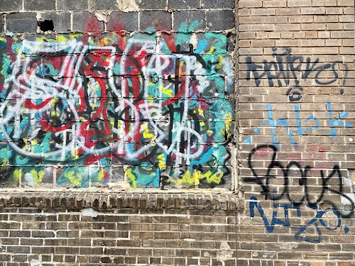 Graffiti on brick wall reads “focus”