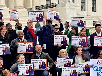 A group of people holding various signs reading Catholics or Jews or Sikhs or Muslims or “People of Faith” speak out—#ConfirmJackson