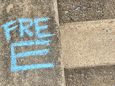 “Free” written in chalk on sidewalk 