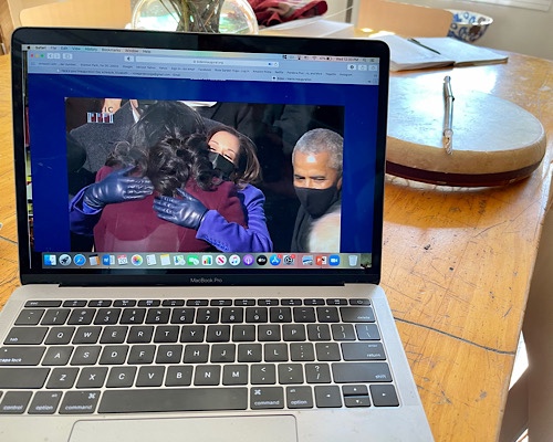 Image of computer screen showing Michelle Obama giving a hug to Kamala Harris at Inauguration Ceremony 