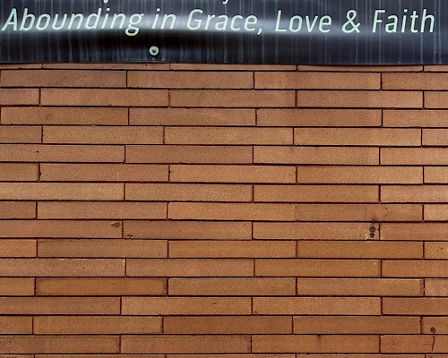 Sign across top of image that reads, “abounding in grace, love, & faith”