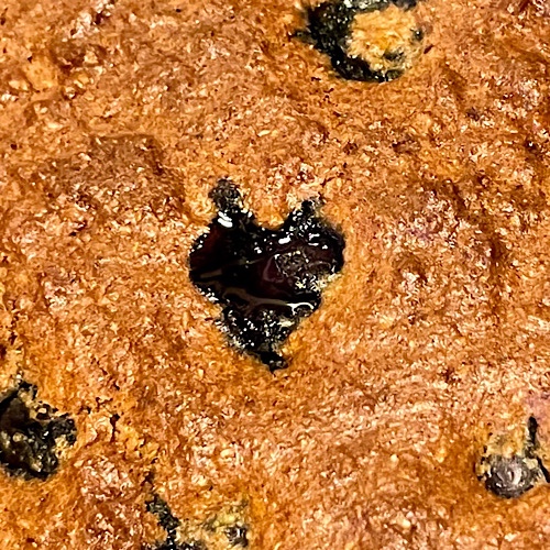Photo of heart-shaped blueberry bubbling through golden cake crust